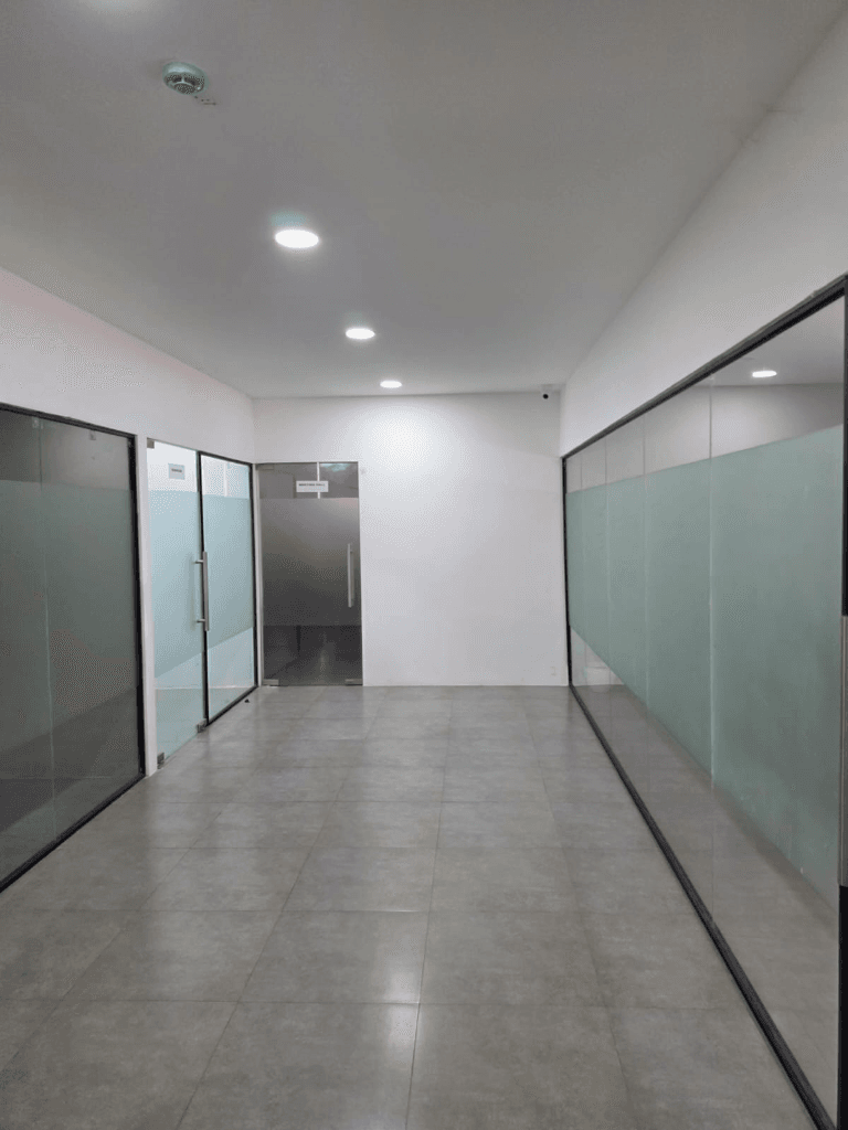 Corridor lined with frosted glass cabin walls and doors